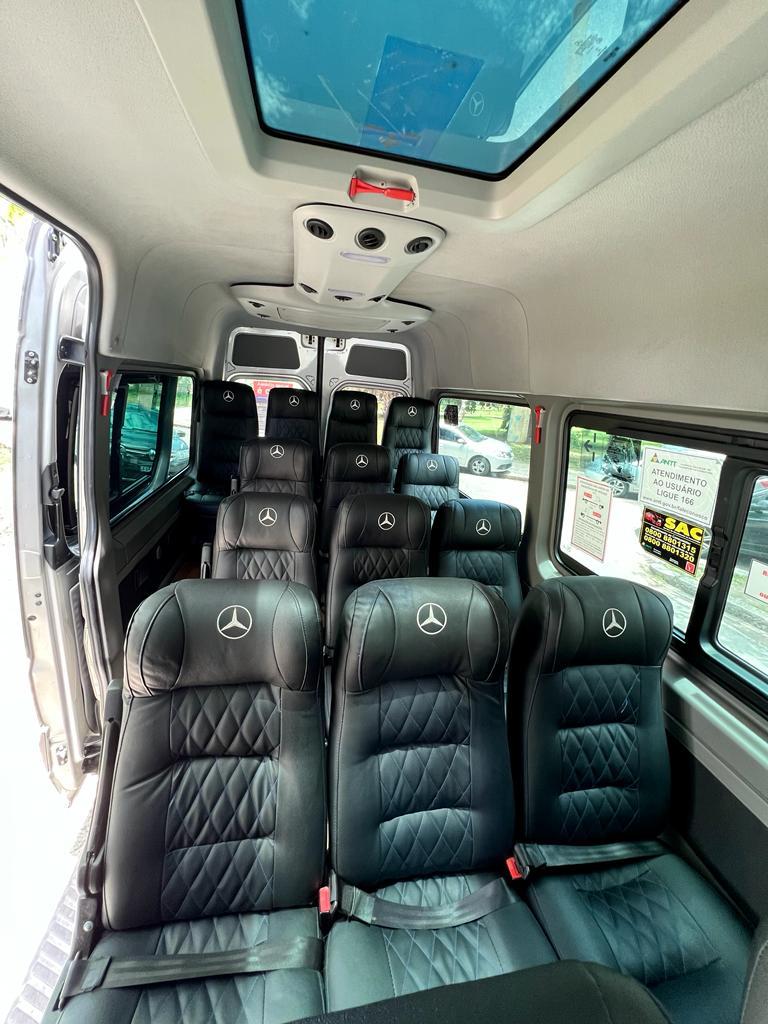 Interior de uma van da Seventy Trans Log assentos de couro pretos com logo da Mercedes-Benz, teto com claraboia e ventilação.